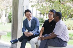 male students sitting around laughing