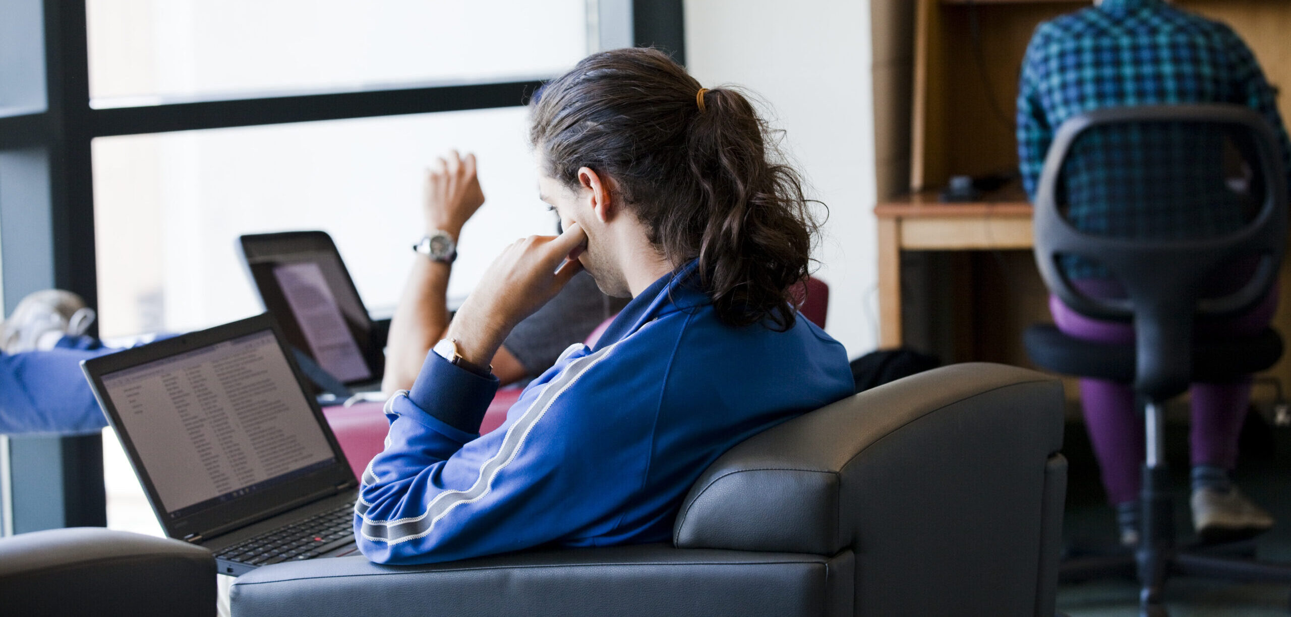 student using laptop at the library